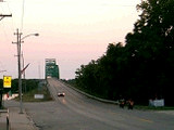 写真: 緑色の橋と日没